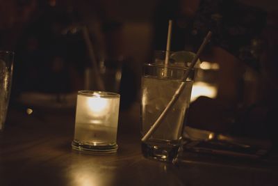 Close-up of illuminated lamp on table