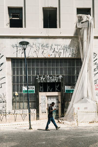 Full length of man on street against building in city