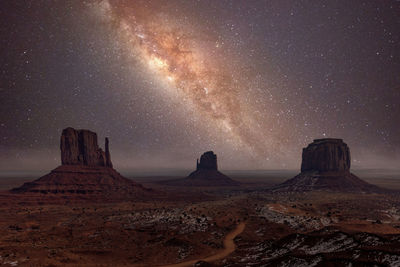 Scenic view of rock formation in desert against sky at night