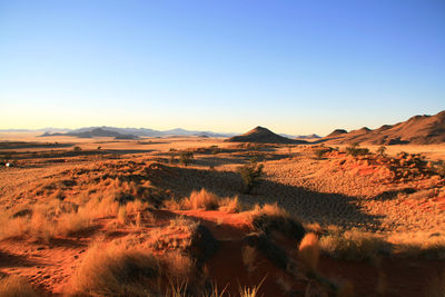 Scenic view of dramatic landscape against clear blue sky