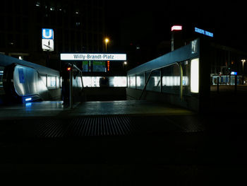 View of illuminated railroad station platform at night