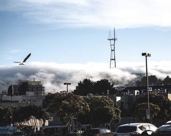 Low angle view of buildings against cloudy sky