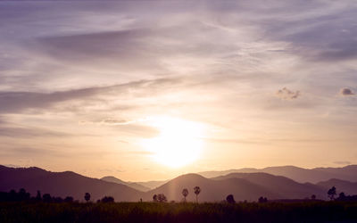 Scenic view of silhouette mountains against sky during sunset