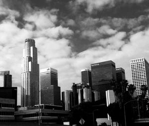 Low angle view of buildings against cloudy sky