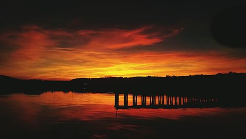 Scenic view of lake against orange sky