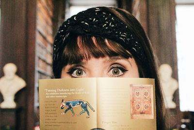 Portrait of woman holding book