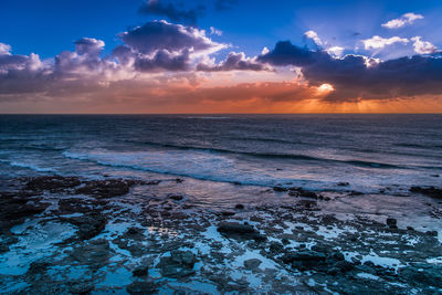 Scenic view of sea against sky during sunset