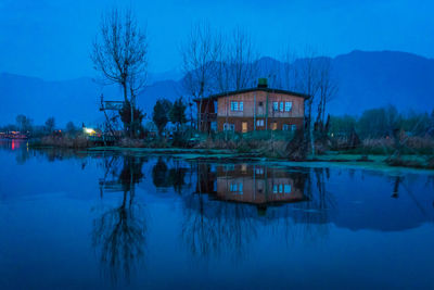 Reflection of building on lake at dusk