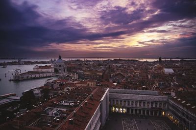 High angle view of buildings in city at sunset