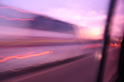 Cars on road at sunset