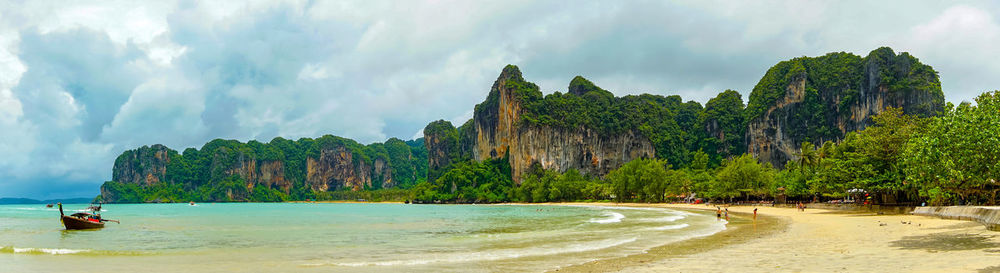 Panoramic view of sea and mountains against sky