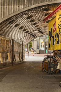 Bicycle parked on street by buildings in city