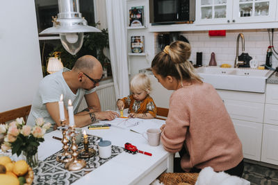 Parents drawing with toddler