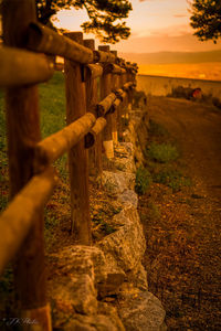 Close-up of fence on field against sky