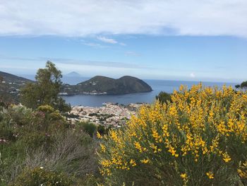 Scenic view of sea and mountains against sky