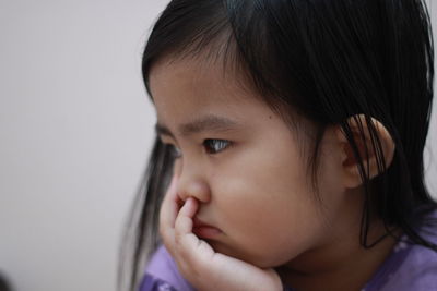 Close-up portrait of cute girl looking away