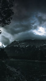 Scenic view of mountains against cloudy sky
