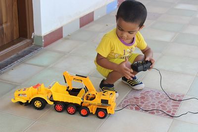 Boy playing with toy car at home