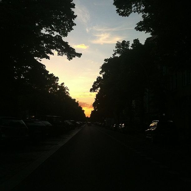 transportation, sunset, tree, the way forward, car, sky, road, land vehicle, mode of transport, diminishing perspective, street, silhouette, cloud - sky, vanishing point, cloud, road marking, no people, nature, outdoors, dusk