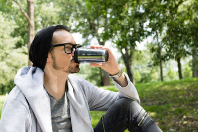 Portrait of young man drinking glasses