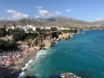 High angle view of sea and mountains against sky