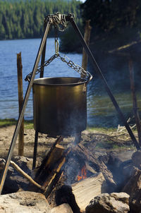 Container over campfire at lakeside