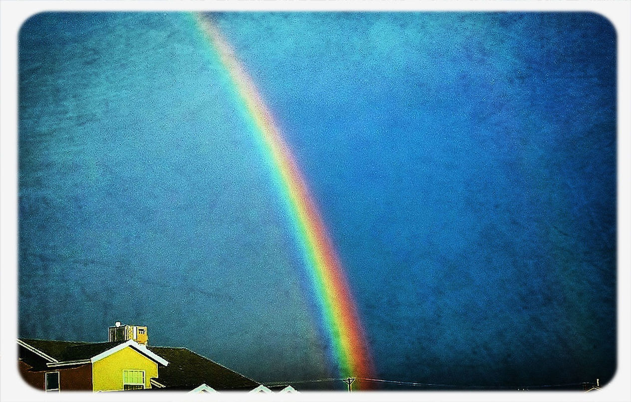 rainbow, multi colored, colorful, sky, blue, scenics, beauty in nature, no people, outdoors, nature, auto post production filter, green color, copy space, tranquility, idyllic, low angle view, landscape, built structure, cloud - sky, architecture