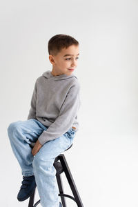 Boy child preschooler smiling and posing on gray background in photo studio