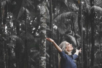 Woman standing in forest