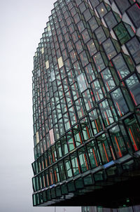 Low angle view of modern glass building against sky