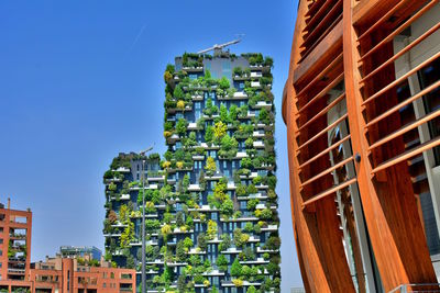 Low angle view of modern buildings against clear blue sky