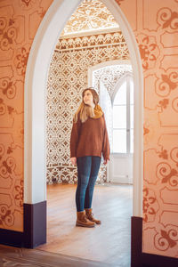 Woman standing in historic building