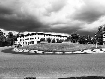 Buildings in city against cloudy sky