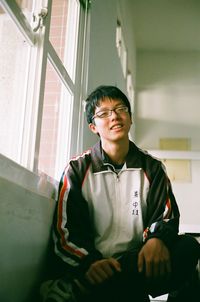 Portrait of young man sitting at home