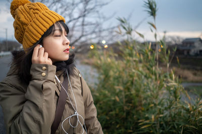 Young woman with eyes closed listening music
