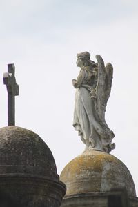 Low angle view of statue against sky