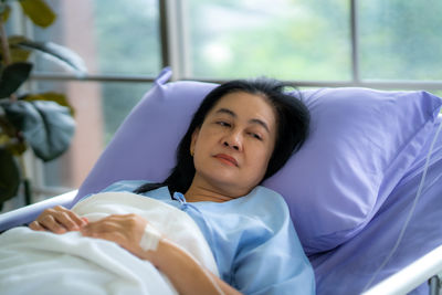 Young woman sleeping on bed at home