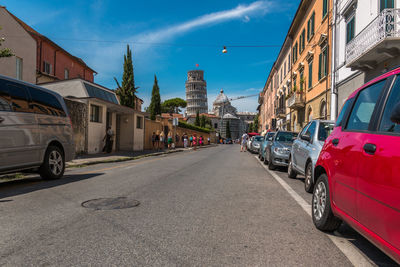 City street by buildings against sky