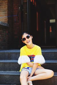 Portrait of smiling girl sitting on staircase