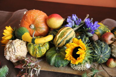 Various flowers in container on table