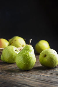 Close-up of apples on table against black background