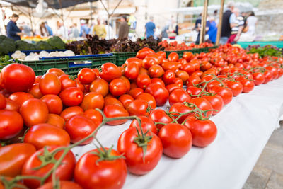 High angle view of tomatoes and vegetables for sale at market stall