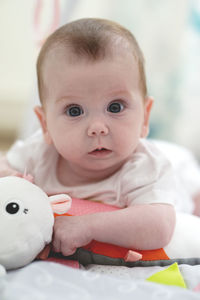 Portrait of cute baby girl with toy