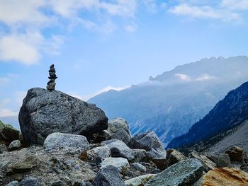 Stack of rocks on mountain against sky