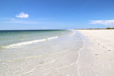 View of beach against blue sky