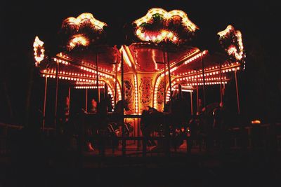 Low angle view of illuminated ferris wheel