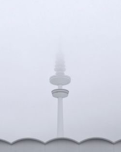 Low angle view of communications tower against sky