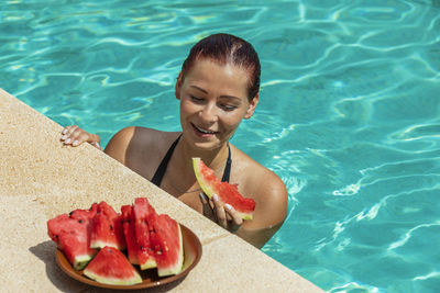 Young woman smiling in swimming pool