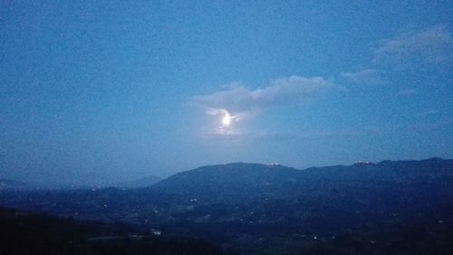 Scenic view of mountains against sky at night