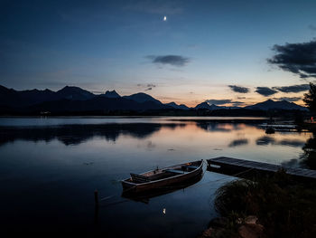 Scenic view of lake against sky at sunset